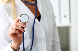 Female medicine doctor hand holding stethoscope head closeup